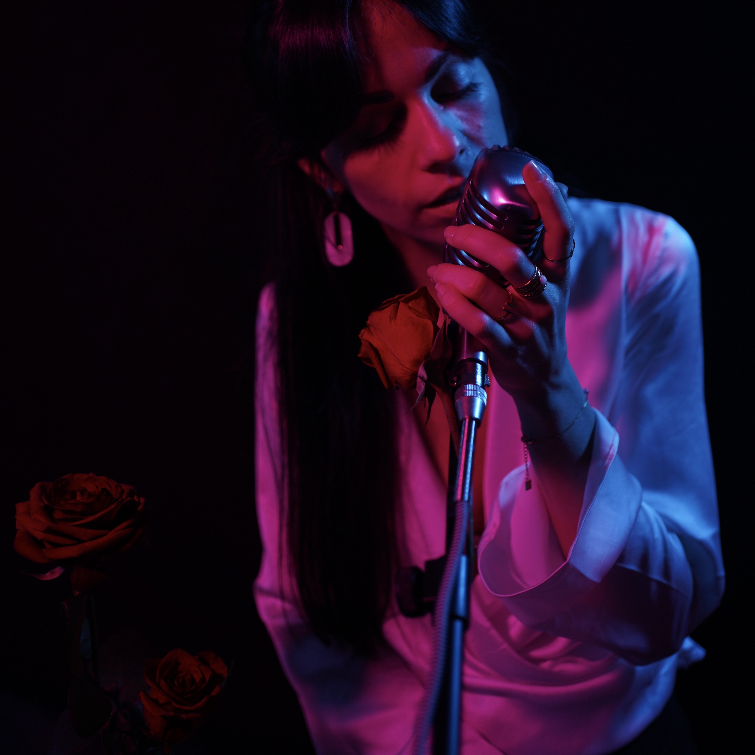 Marie singing under red and blue stage lights