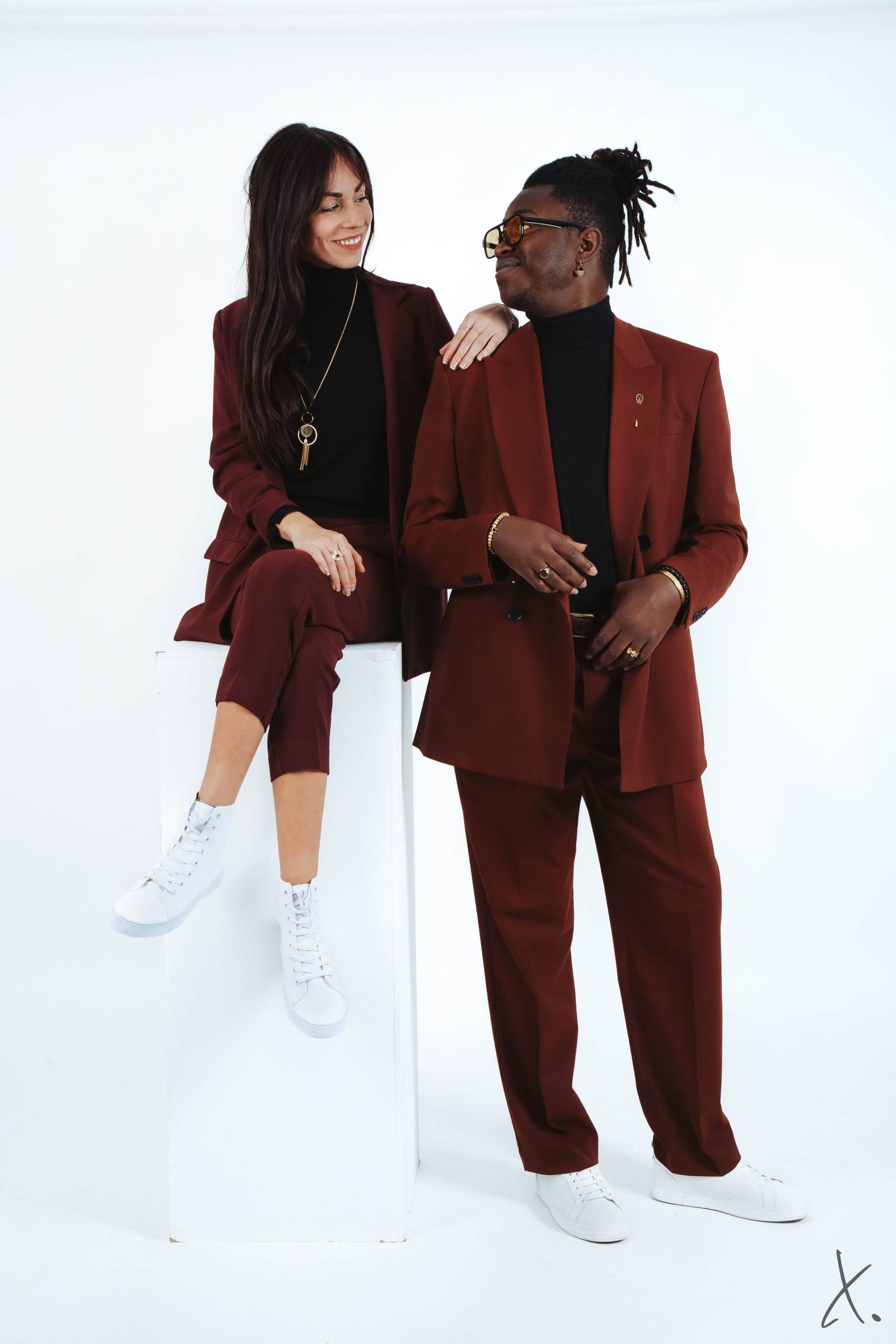 Marie Oya and Eric Maseko in burgundy suits
