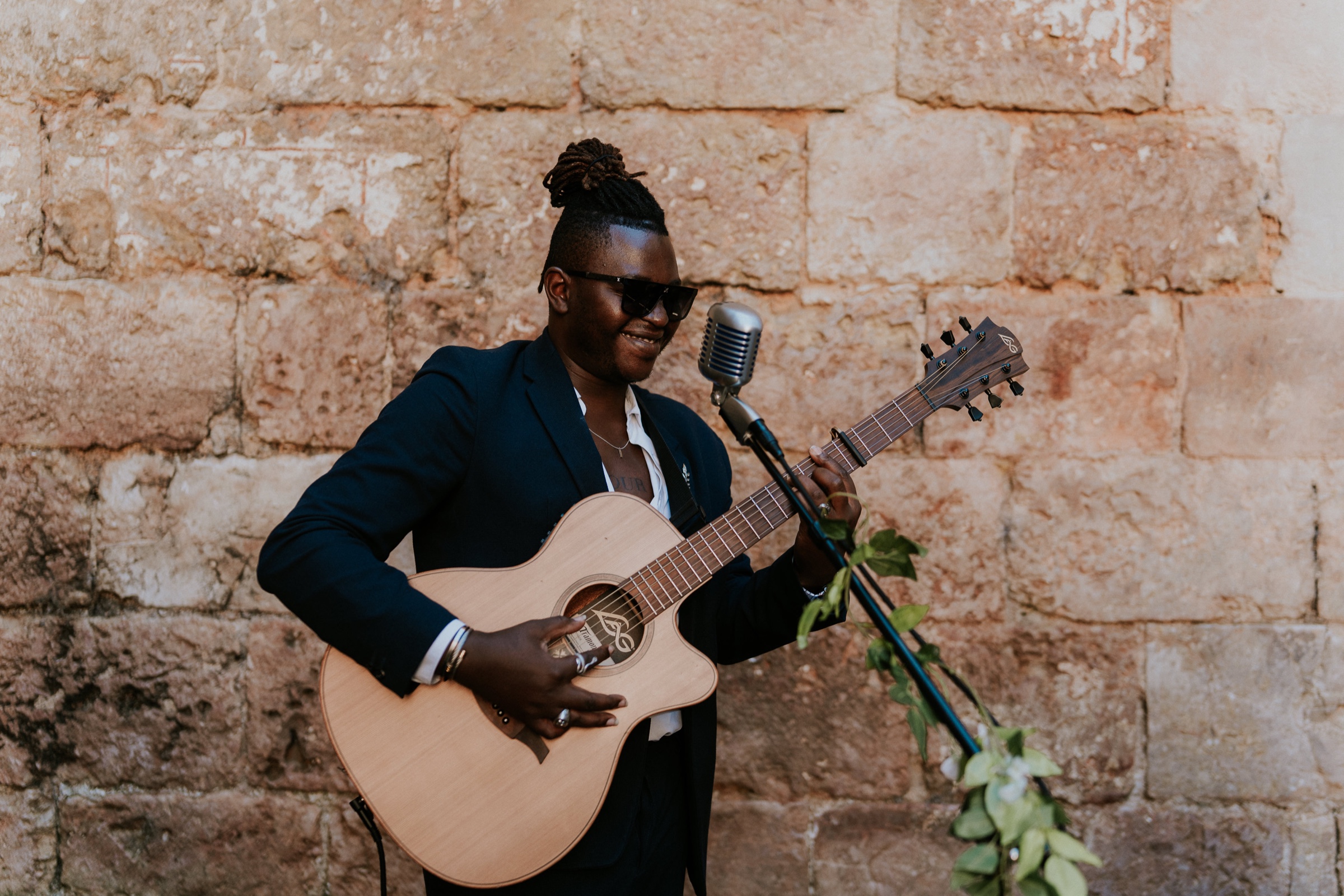 Eric Maseko playing guitar at a reception