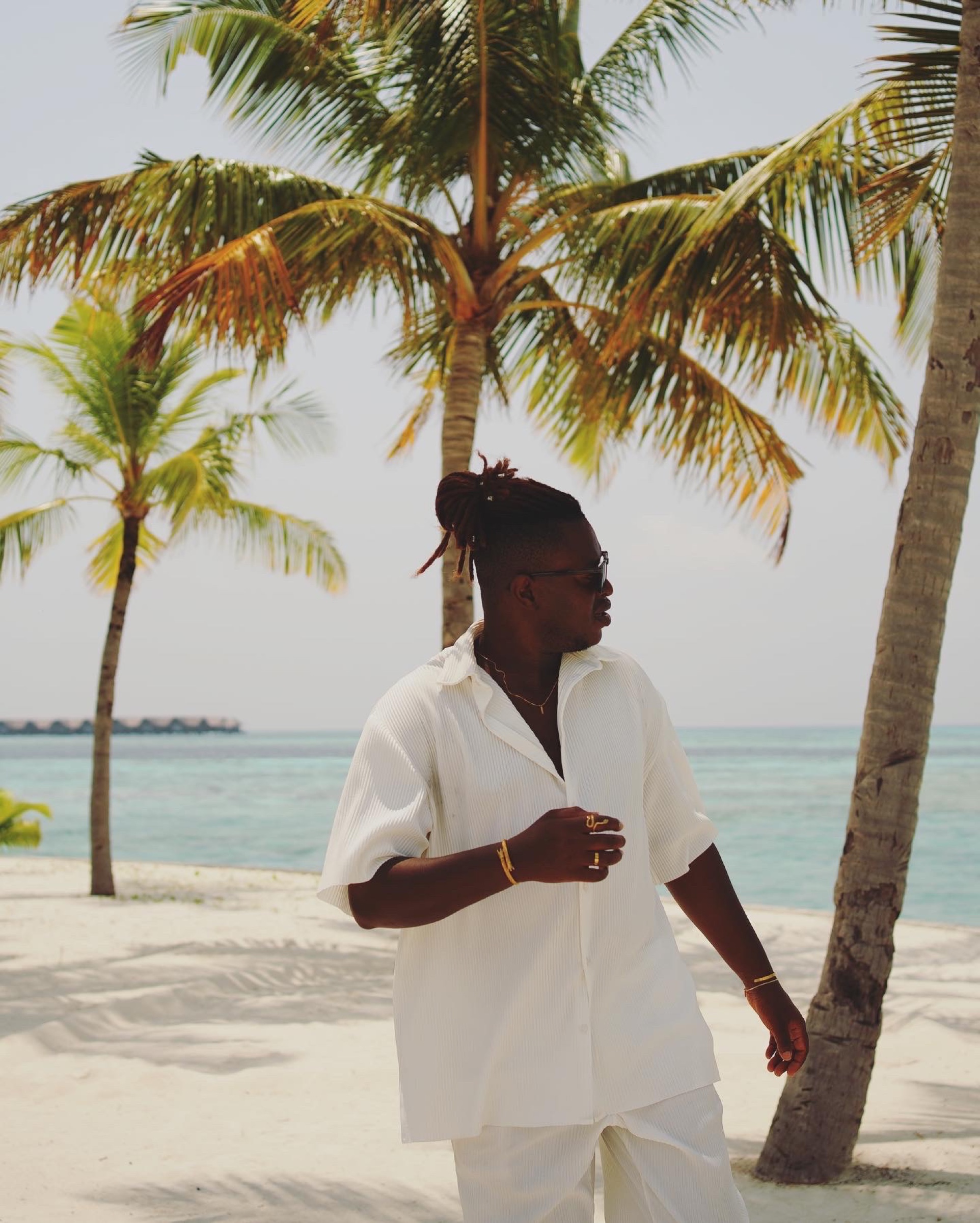 Portrait of Eric Maseko beneath the palm trees