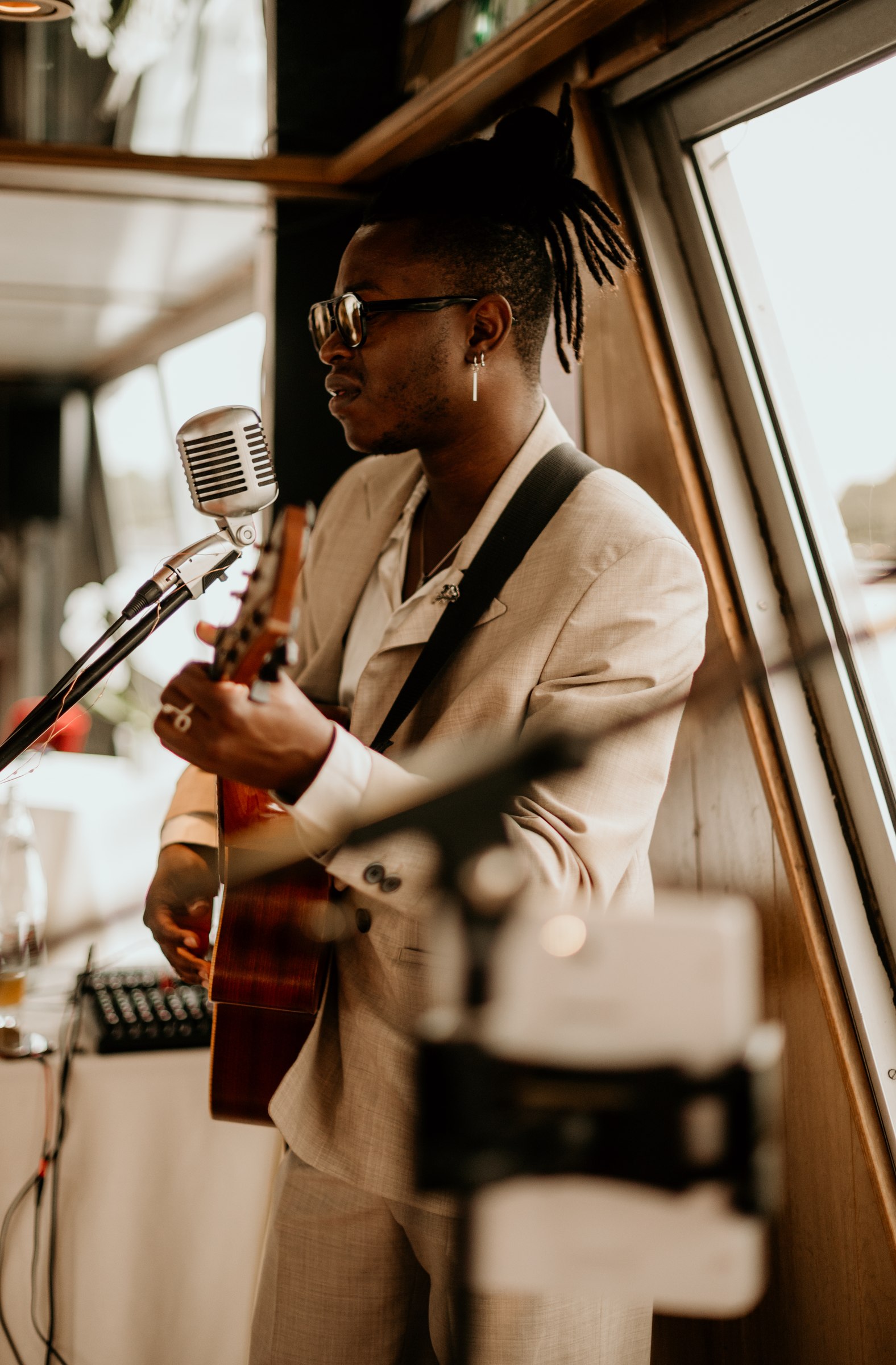 Eric Maseko playing guitar at a private concert