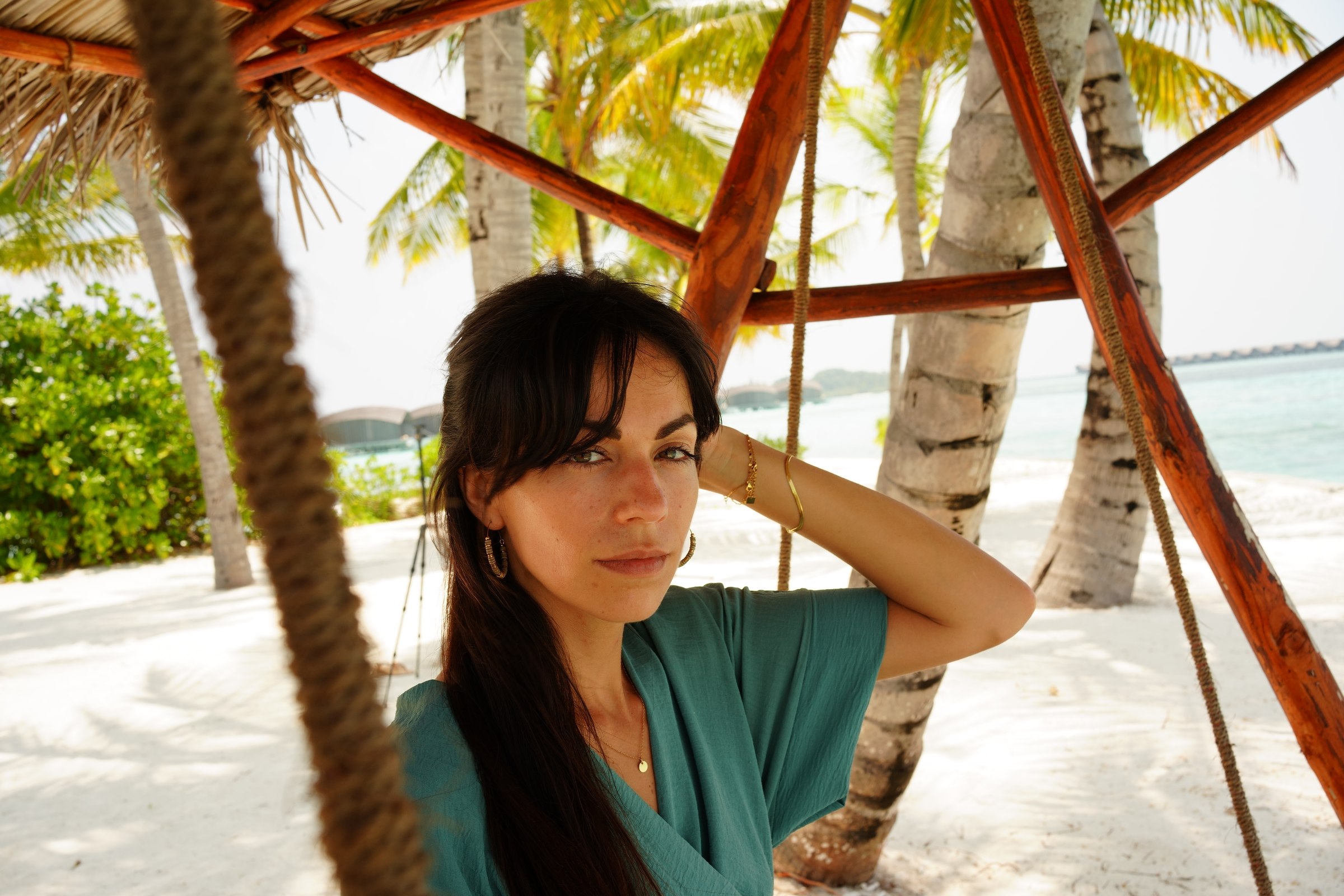 Marie resting beneath the palm trees in the Maldives