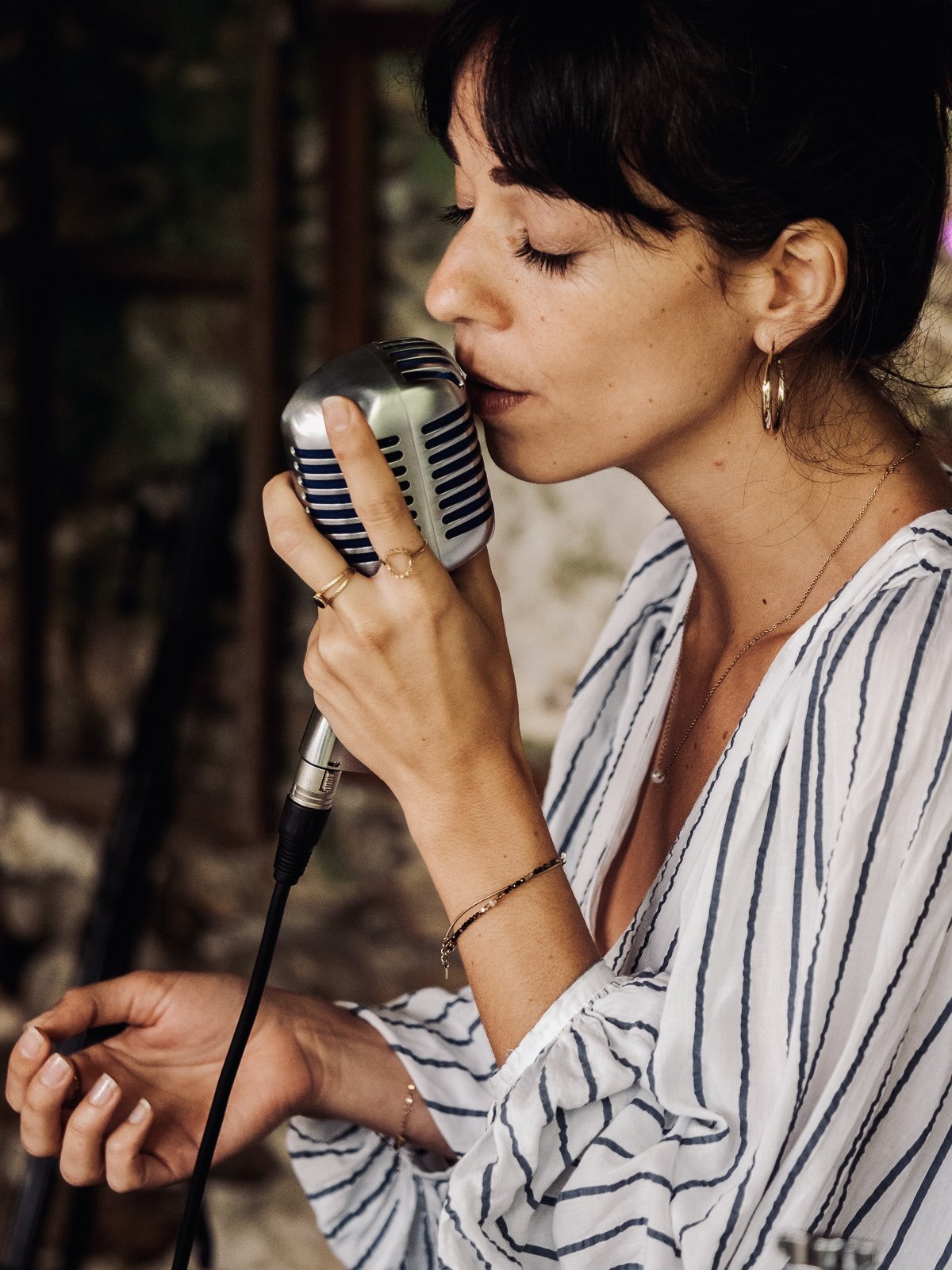 Marie singing into a vintage microphone