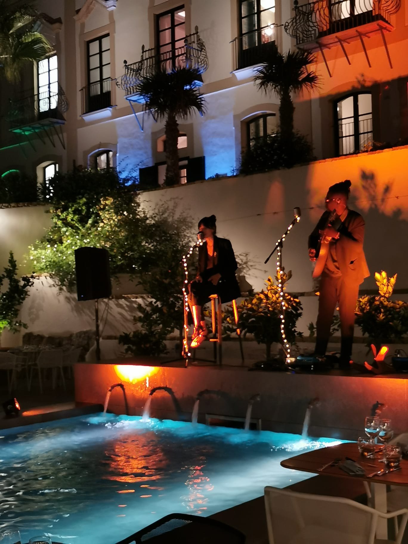 LoungeDuo performing beside a pool